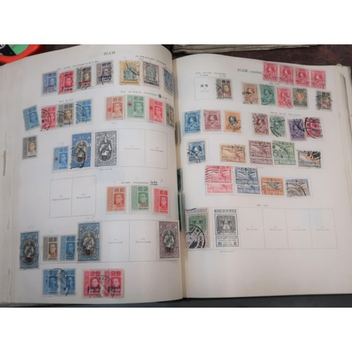 219 - Two large green Ideal postage stamp albums containing an extensive collection of World stamps, toget... 