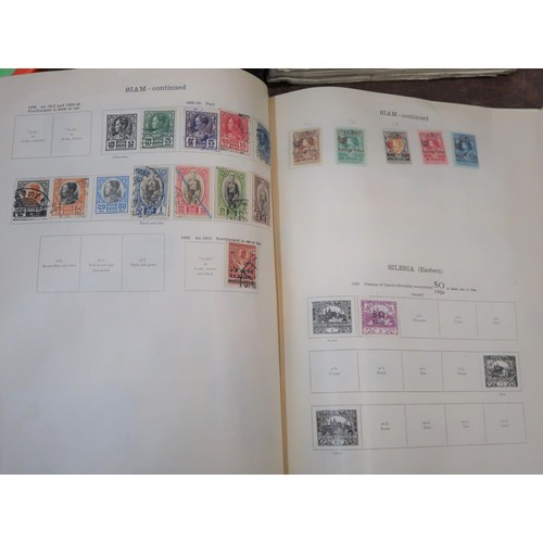 219 - Two large green Ideal postage stamp albums containing an extensive collection of World stamps, toget... 