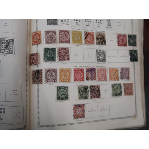 219 - Two large green Ideal postage stamp albums containing an extensive collection of World stamps, toget... 