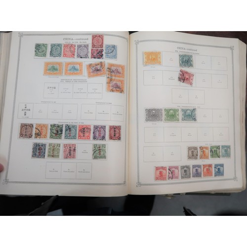 219 - Two large green Ideal postage stamp albums containing an extensive collection of World stamps, toget... 