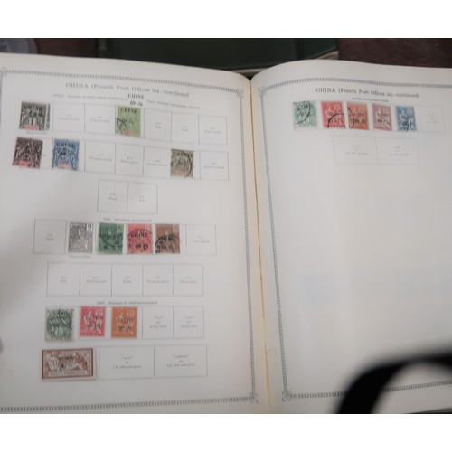 219 - Two large green Ideal postage stamp albums containing an extensive collection of World stamps, toget... 