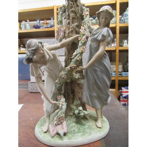 432 - Lladro table lamp in the form of two girls beside a tree with a garland of flowers, 15ins high exclu... 