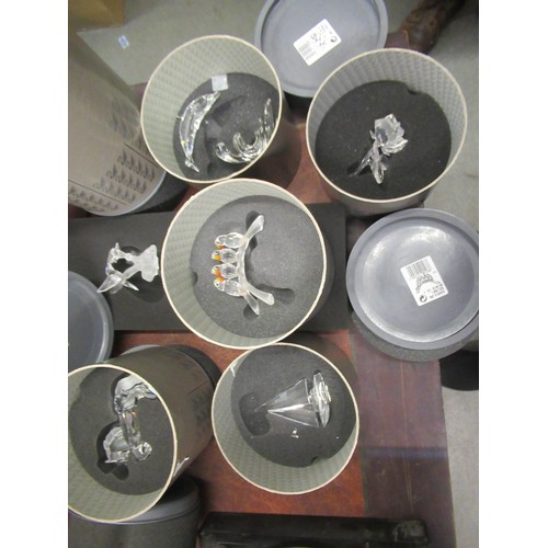 613 - Collection of fourteen various Swarovski crystal figures, in original grey cylindrical boxes