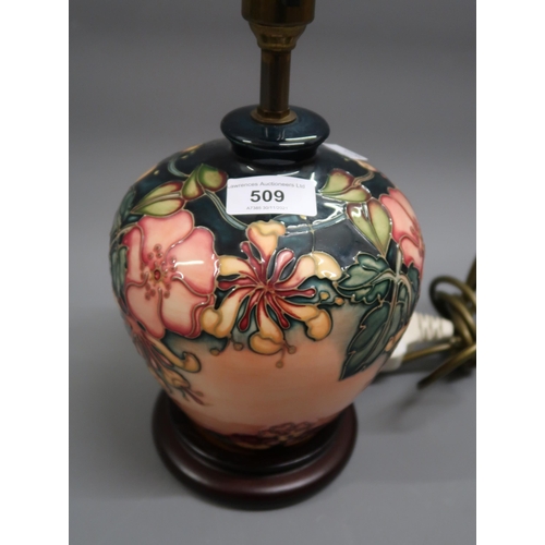 509 - Modern Moorcroft table lamp decorated with Autumn berries and foliage on a cream ground, 7.5ins high... 