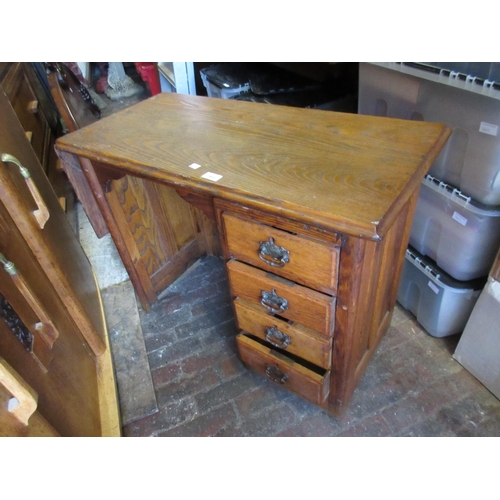 2447 - Early 20th Century child's elm single pedestal desk with drop flap, 34.5ins wide x 17ins deep x 25.5... 