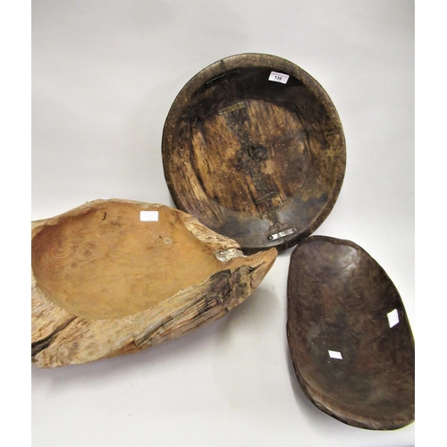 139 - Two wooden dug-out bowls together with another similar