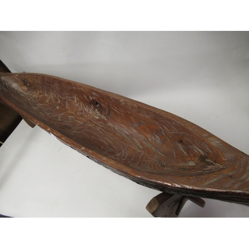 199 - Native Carved hardwood model canoe on a hardwood stand, 43ins long