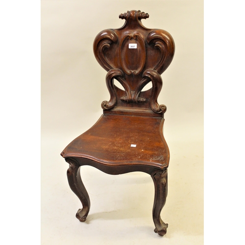 2037 - Victorian carved mahogany hall chair with a shaped back and panel seat on cabriole front supports