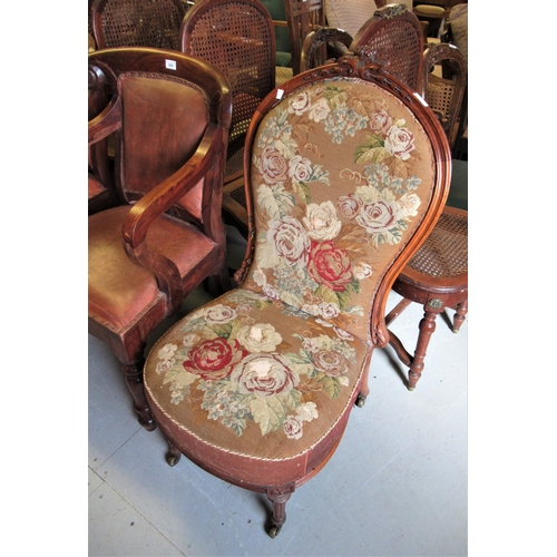 2040 - Victorian walnut low seat nursing chair with original needlepoint upholstery