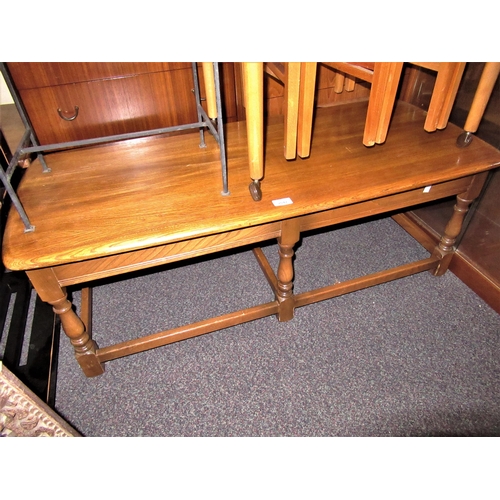 2042 - Ercol rectangular light elm coffee table on turned supports with stretchers, 44ins x 19ins x 16ins h... 