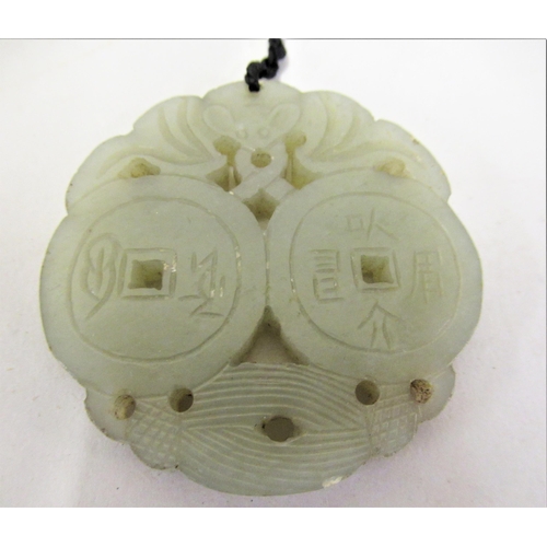 227 - Chinese green stone carved pierced pendant on cord