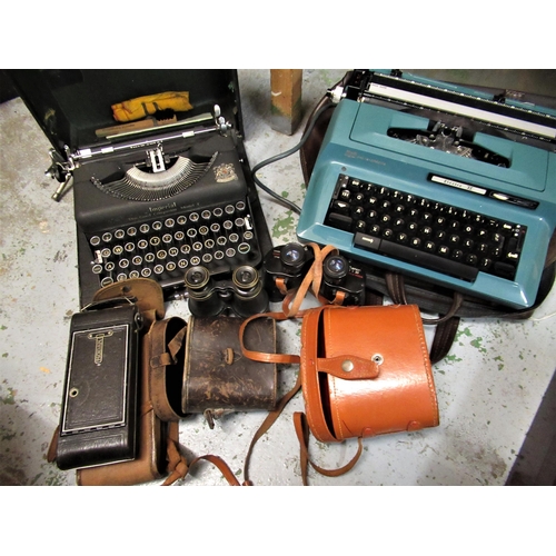 237 - Two portable typewriters, two pairs of binoculars and a folding camera