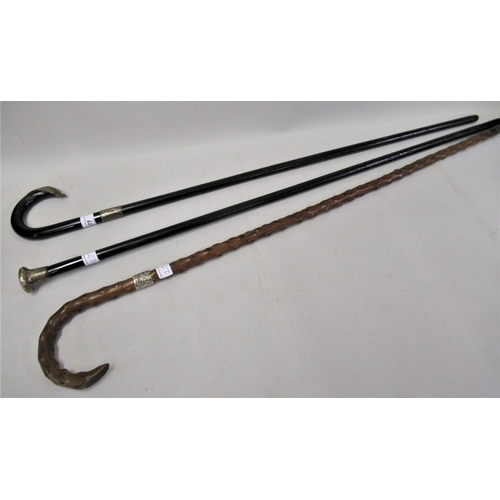 277 - Two ebonised walking canes with silver mounts, and another natural form walking cane with silver col... 