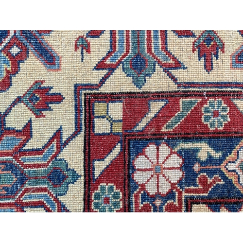 32 - Good quality modern Afghan Ziegler type carpet with an all-over palmette design on a red ground with... 