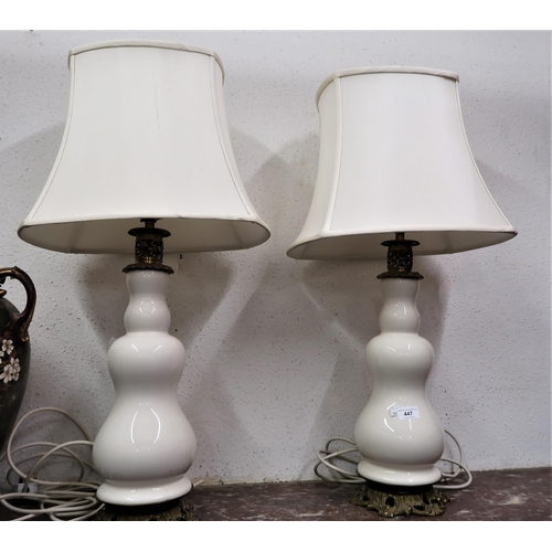 447 - Pair of 20th Century cream glazed pottery baluster form table lamps with gilt metal mounts