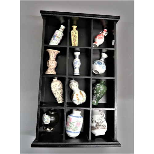 450 - Collection of twelve Japanese porcelain miniature vases housed in a wooden display case