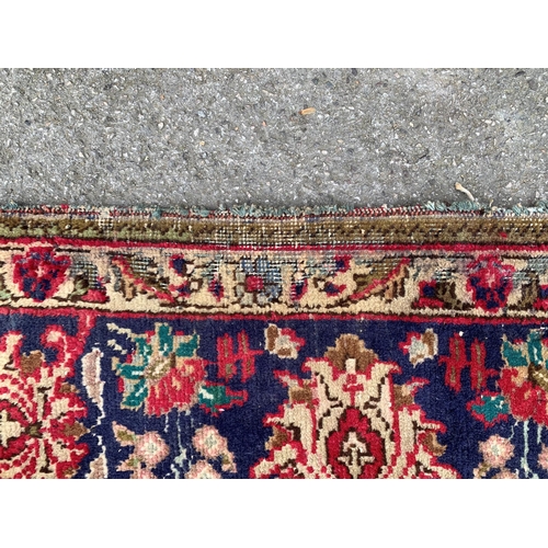 6 - Tabriz carpet with a lobed medallion and all-over floral design on a red ground with corner designs ... 