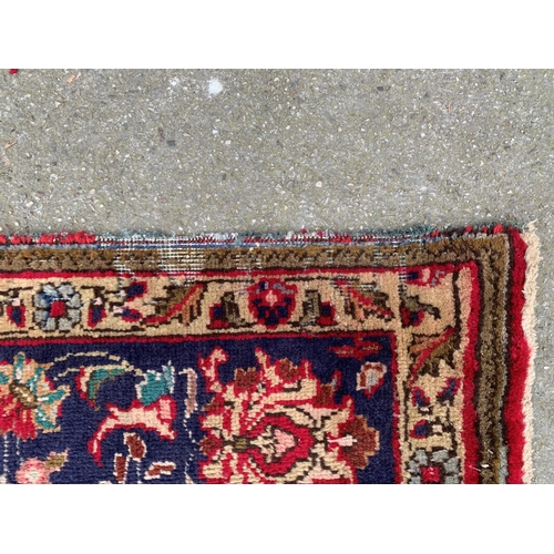 6 - Tabriz carpet with a lobed medallion and all-over floral design on a red ground with corner designs ... 