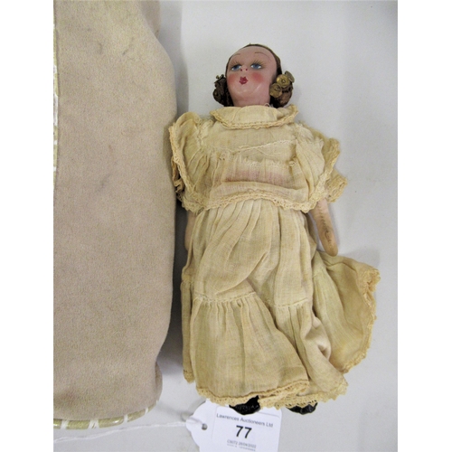 77 - Small 1930's  painted composition doll wearing a cream dress