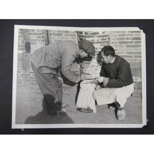 231 - Red photograph album containing a collection of various Chinese photographs and postcards