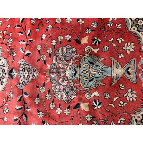 25 - Large Indo Persian carpet with a medallion and vase design on a salmon ground with corner designs an... 