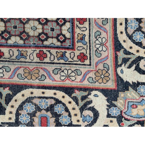 25 - Large Indo Persian carpet with a medallion and vase design on a salmon ground with corner designs an... 