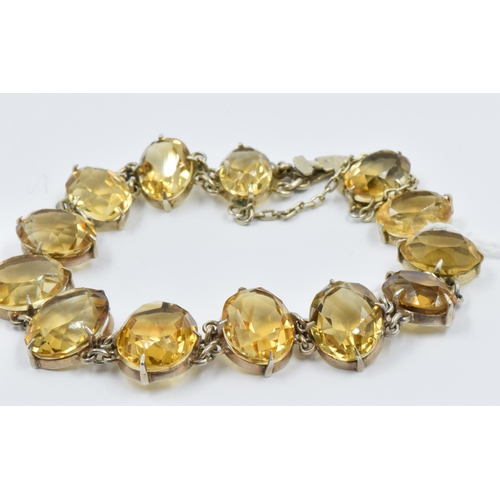 1022 - 19th Century graduated citrine silver mounted bracelet set thirteen citrines, the largest approximat... 