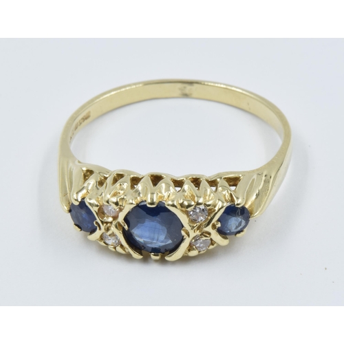 1029 - 9ct Yellow gold three stone sapphire and four stone diamond ring