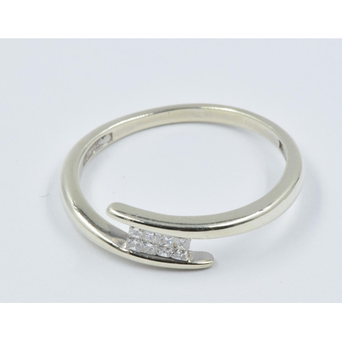 1032 - 9ct White gold crossover ring set eight small square cut diamonds