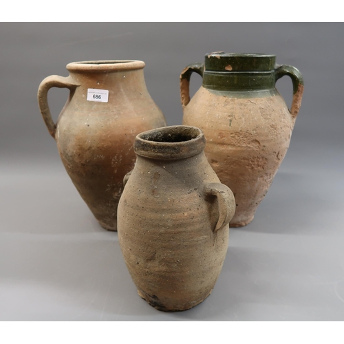 686 - Group of three various Mediterranean terracotta oil jars, the largest 14ins high