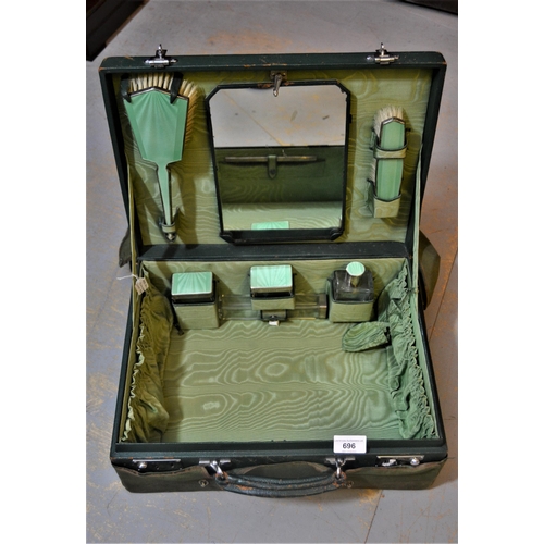 696 - 1930's Green leather dressing case, the hinged cover enclosing a fitted interior with original green... 