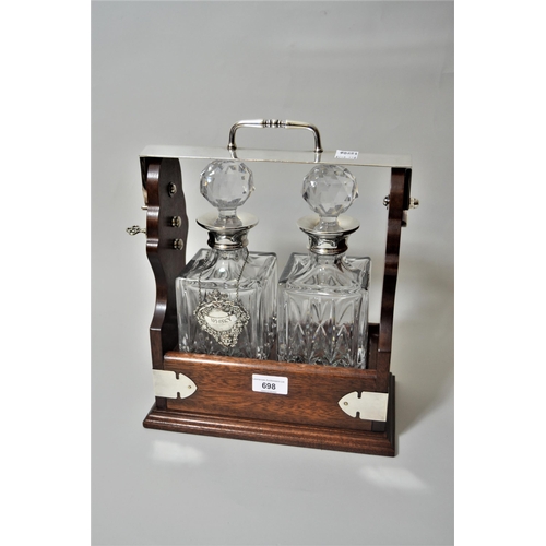 698 - Reproduction mahogany and silver plated two bottled tantalus with silver collars and a single silver... 