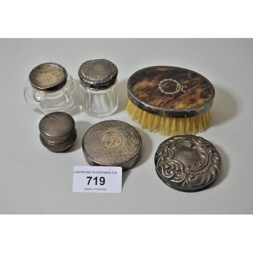 719 - Silver compact, three silver top jars, two silver backed brushes and a silver cover