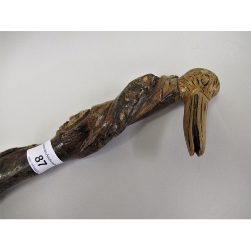 87 - Carved briar wood Folk Art walking stick with bird's head handle, 30.25ins long