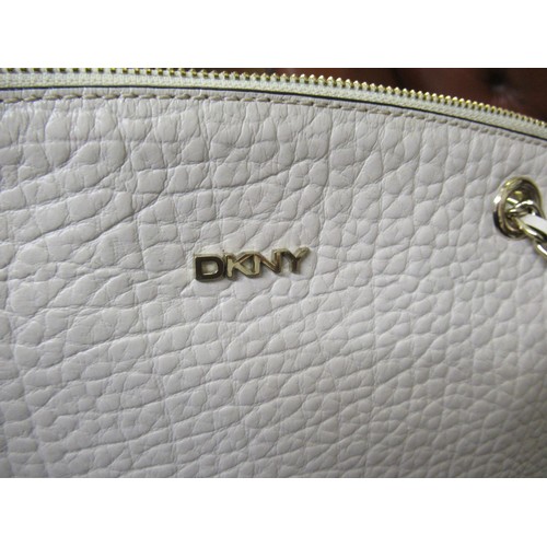 32 - DKNY Cream pebbled leather shoulder bag with chain handles, another DKNY black suede shoulder bag an... 