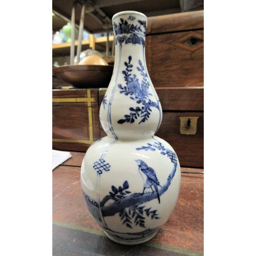 454 - Small Chinese porcelain gourd shaped vase painted with figures and flowering trees in blue and white... 