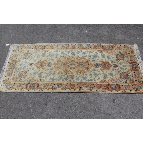 19 - Indo Persian part silk rug with a medallion and all-over floral design on an ivory ground with borde... 