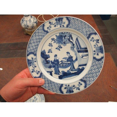 473 - Pair of modern Chinese blue and white plates decorated with figures on a terrace, six character mark... 