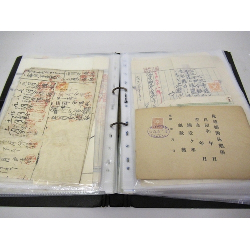 143 - Album containing a collection of Japanese revenue stamps