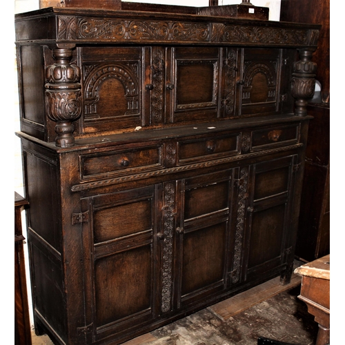 1813 - Mid 20th Century oak court cupboard, the top with three carved panelled doors flanked by turned carv... 