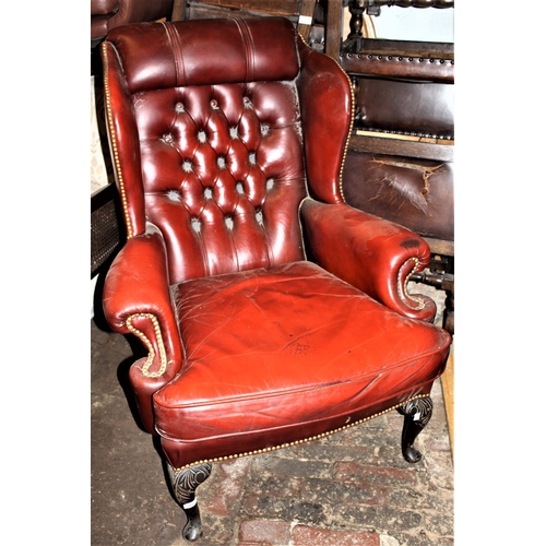 1815 - 20th Century red leather button upholstered wingback armchair with loose cushion, on carved cabriole... 