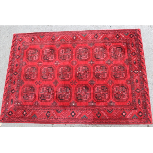 2 - Modern Turkoman design machine woven rug with multiple gols and borders on a red ground, 80ins wide ... 