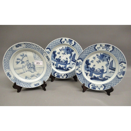 473 - Pair of modern Chinese blue and white plates decorated with figures on a terrace, six character mark... 