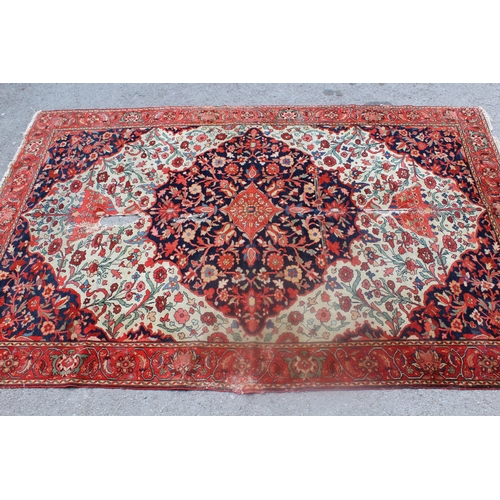 7 - Antique Baktiari rug with a medallion and all-over stylised floral design on an ivory ground, with c... 