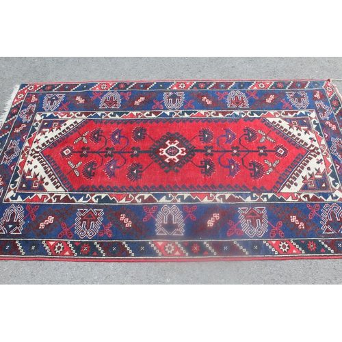 8 - Turkish rug on red ground with medallion design and borders, 57ins x 33ins