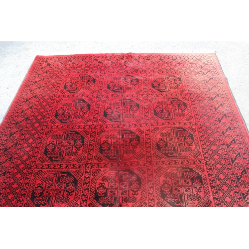 9 - Afghan carpet on wine ground, 115ins x 79ins