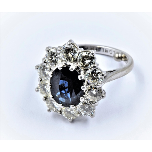 917 - Large 18ct white gold and platinum oval sapphire and diamond cluster ring, the central sapphire appr... 