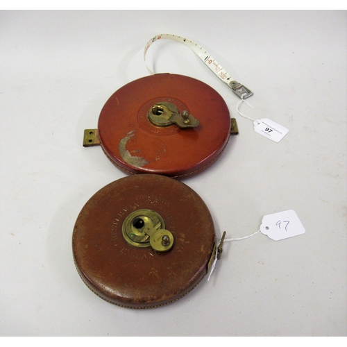 97 - Two circular leather cased tape measures