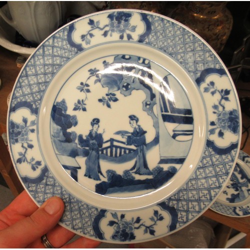 473 - Pair of modern Chinese blue and white plates decorated with figures on a terrace, six character mark... 