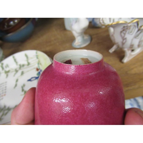 521 - Reproduction Chinese tea bowl with cerise mottled glaze, with wax part seal to base, 3.5ins diameter